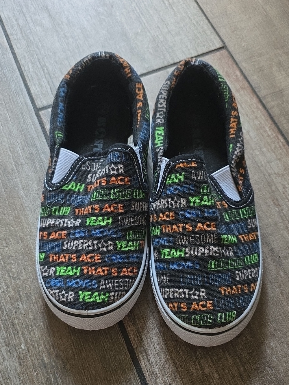 Kids Slip-On Sneakers in Black with Multicolor Text